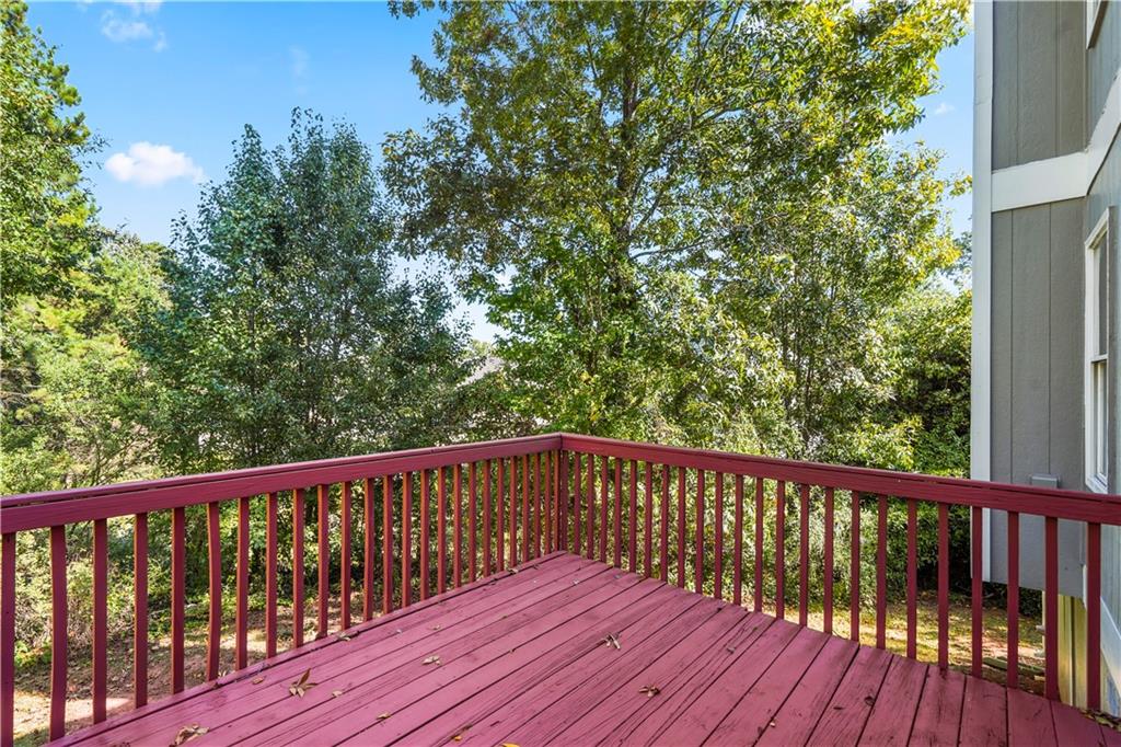 826 Shore Drive Lithonia, GA 30058 - Photo 14 of 42 a balcony with wooden floor and trees in the background