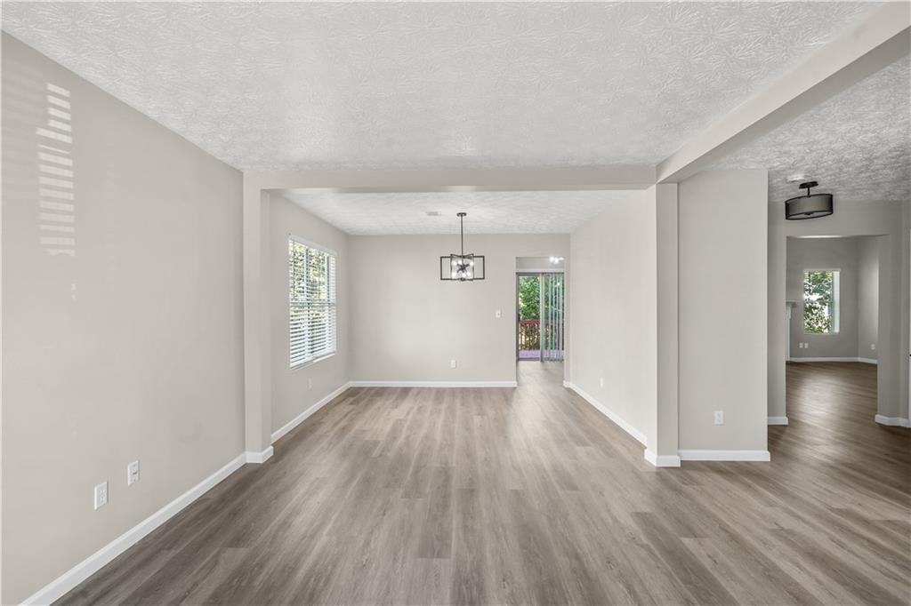 826 Shore Drive Lithonia, GA 30058 - Photo 16 of 42 wooden floor in an empty room with a window