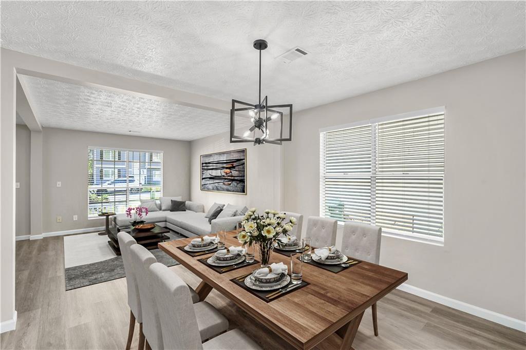 826 Shore Drive Lithonia, GA 30058 - Photo 17 of 42 a view of a dining room with furniture window and wooden floor