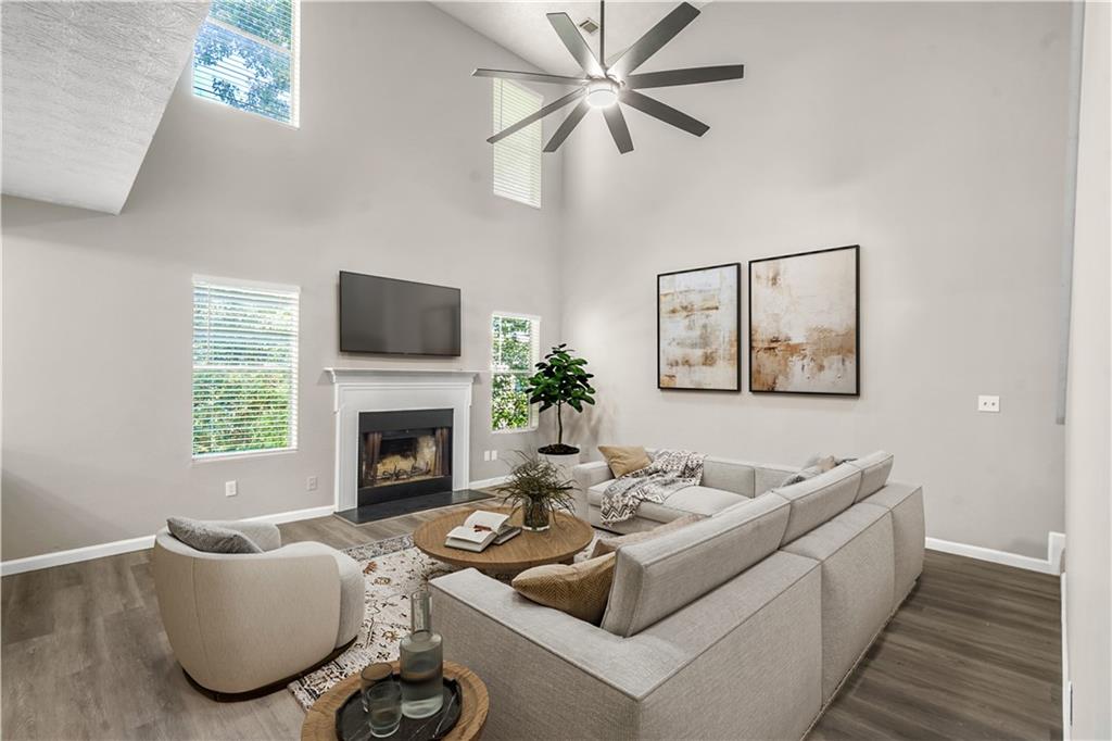 826 Shore Drive Lithonia, GA 30058 - Photo 2 of 42 a living room with furniture a fireplace and a large window