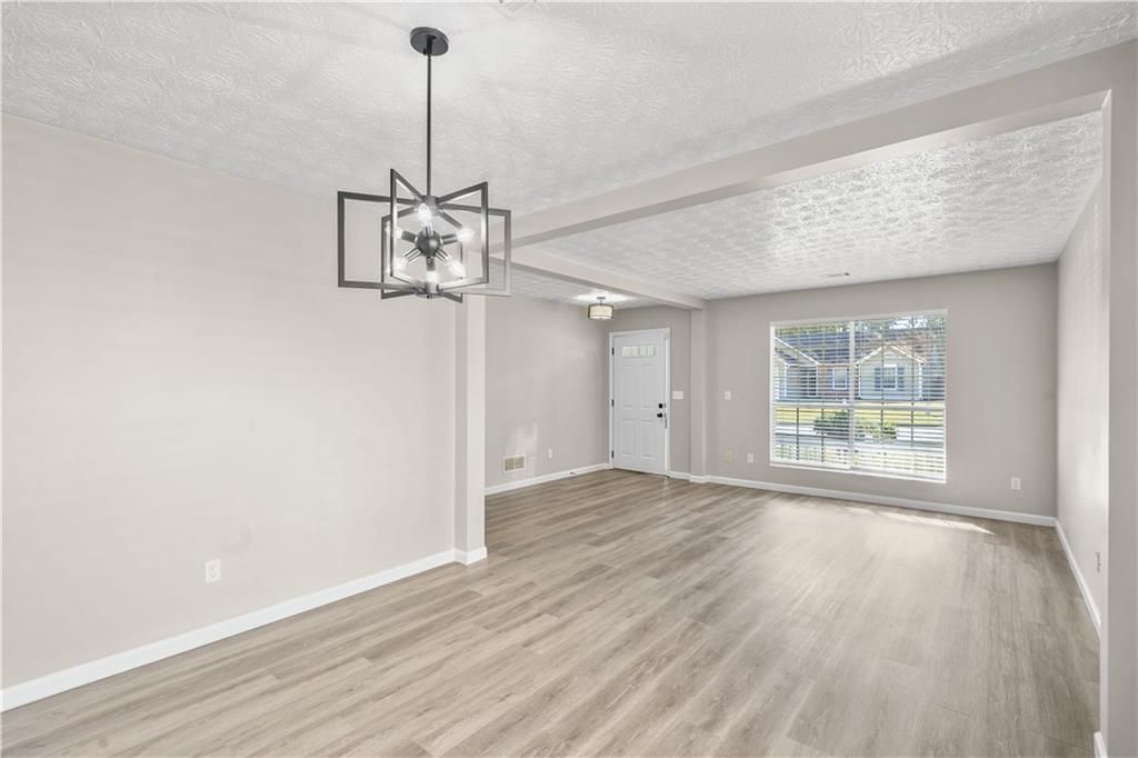 826 Shore Drive Lithonia, GA 30058 - Photo 21 of 42 a view of a room with wooden floor window and a ceiling fan