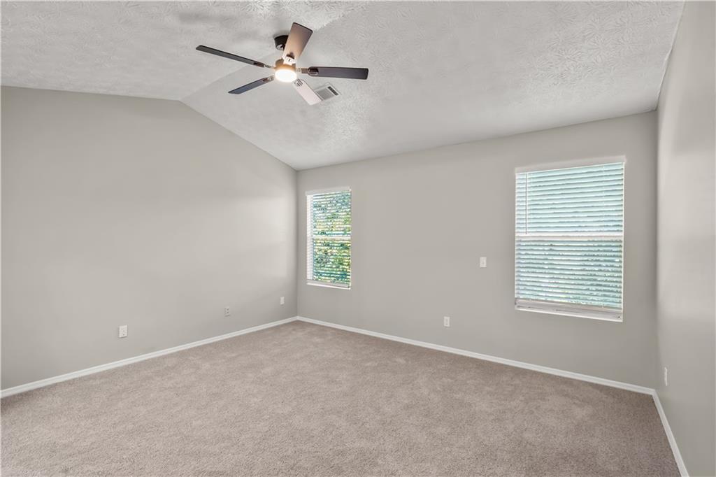 826 Shore Drive Lithonia, GA 30058 - Photo 24 of 42 an empty room with windows and fan
