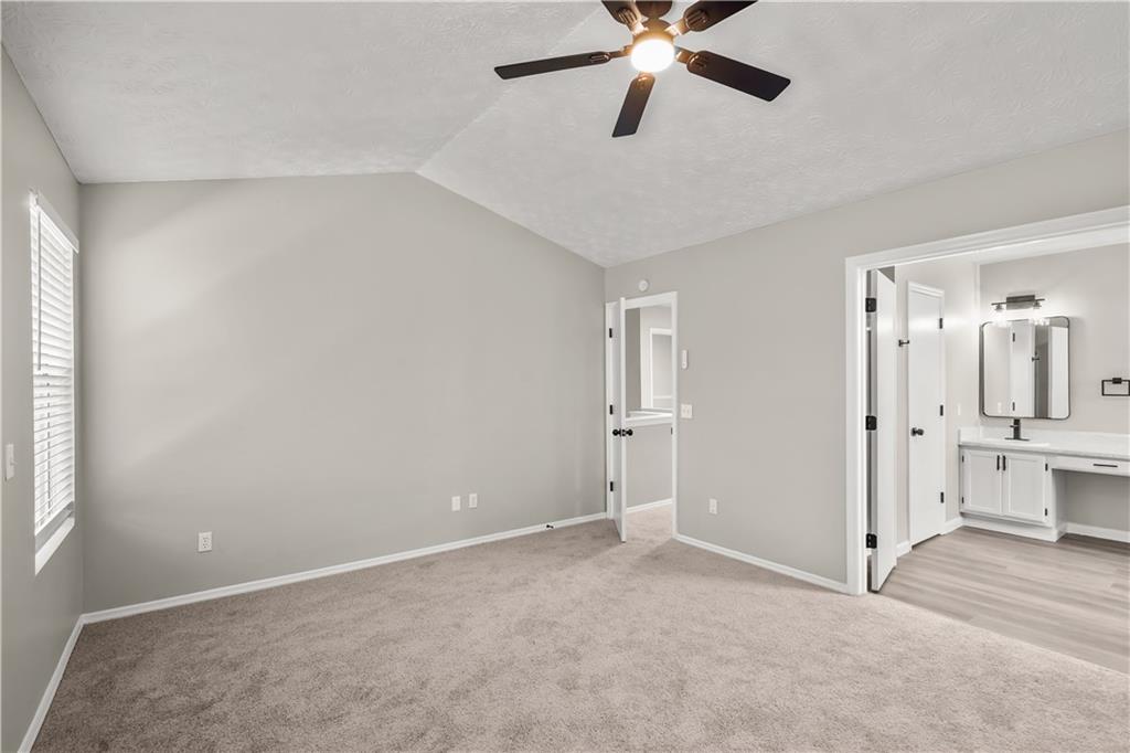 826 Shore Drive Lithonia, GA 30058 - Photo 25 of 42 a view of a big room with chandelier fan and windows