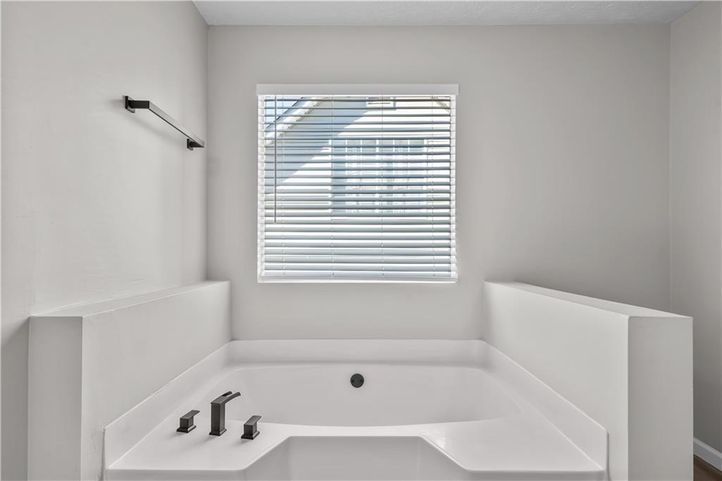 826 Shore Drive Lithonia, GA 30058 - Photo 27 of 42 a white bath tub sitting next to a window