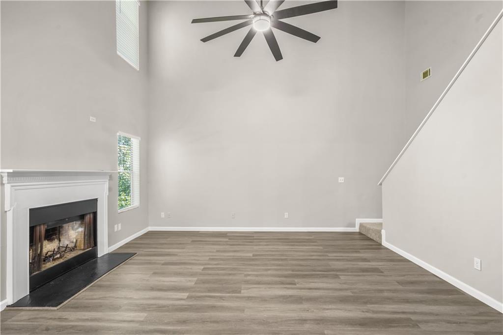 826 Shore Drive Lithonia, GA 30058 - Photo 5 of 42 a view of an empty room with wooden floor and a fireplace