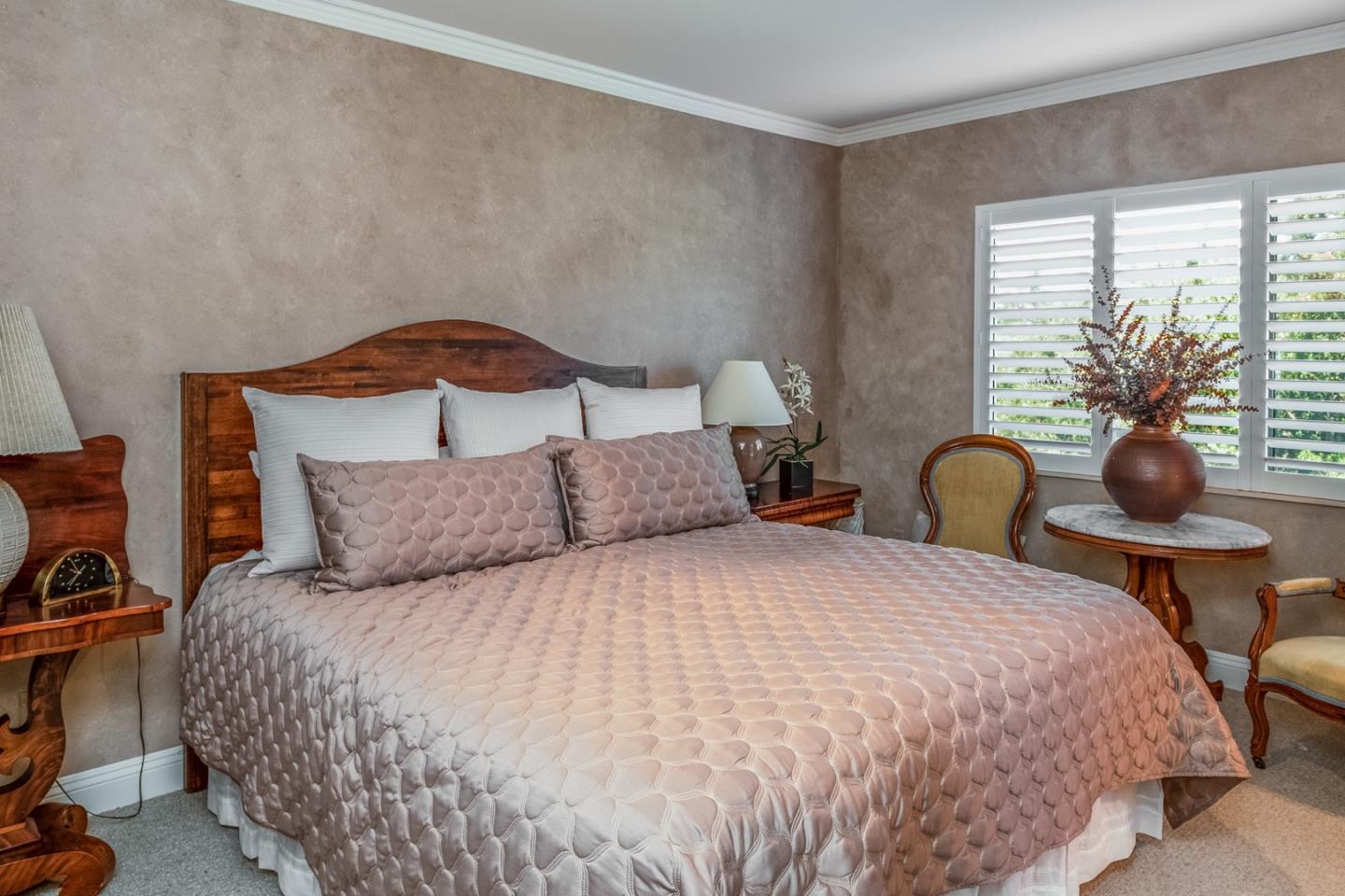 1020 Rodeo Road Pebble Beach, CA 93953 - Photo 26 of 38 a bedroom with a bed and a potted plant