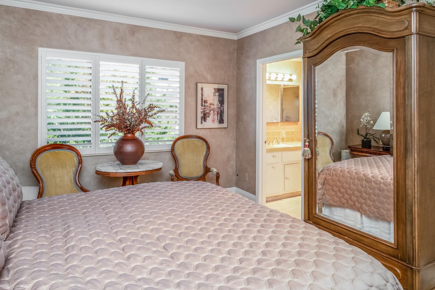 1020 Rodeo Road Pebble Beach, CA 93953 - Photo 28 of 38 a bedroom with a bed and dresser with mirror