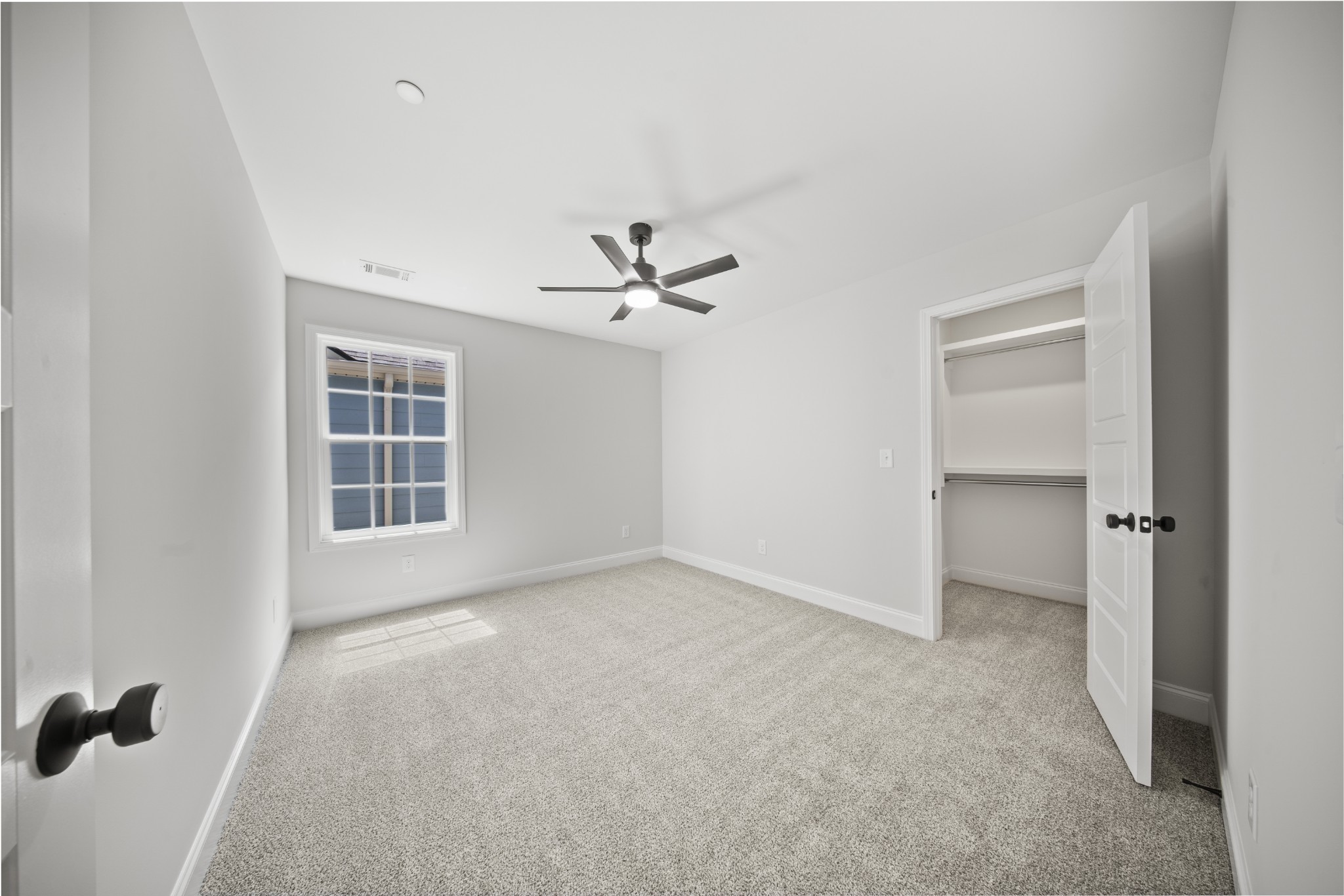 130 Gower Street Pleasant View, TN 37146 - Photo 20 of 30 an empty room with windows and ceiling fan