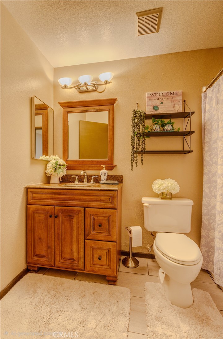 2124 Snowberry Court Simi Valley, CA 93063 - Photo 16 of 23 a bathroom with a toilet a sink and mirror