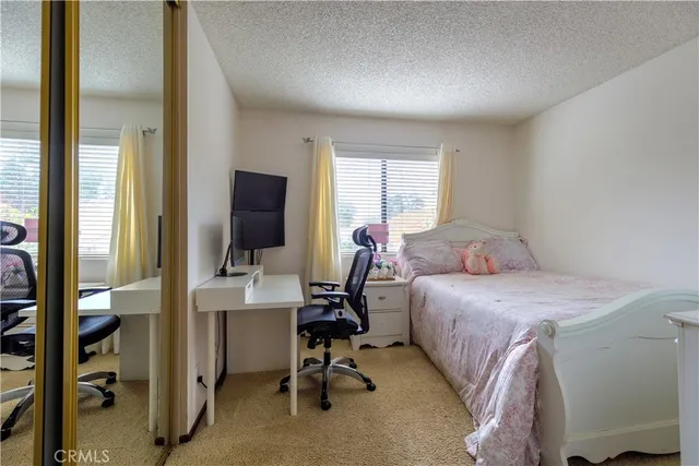 a bedroom with a bed and a desk