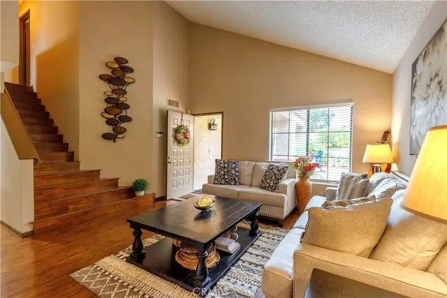 a living room with furniture and wooden floor