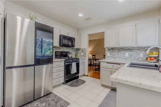 a kitchen with a refrigerator stove and sink