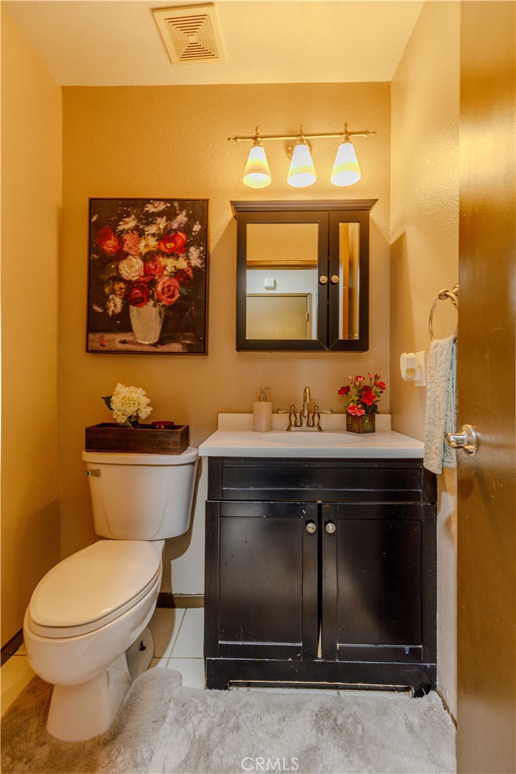 2124 Snowberry Court Simi Valley, CA 93063 - Photo 10 of 23 a bathroom with a toilet sink and mirror