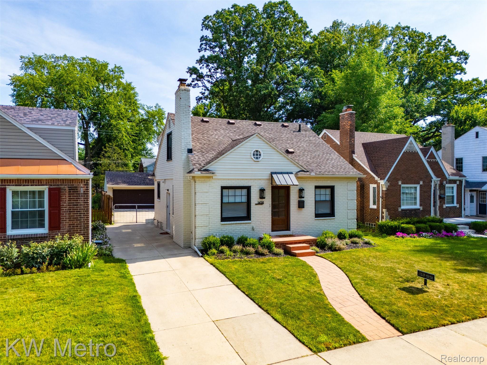 1458 Hampton Road Grosse Pointe, MI 48236 - Photo 34 of 43 White brick exterior featuring black-framed windows and a coordinating awning