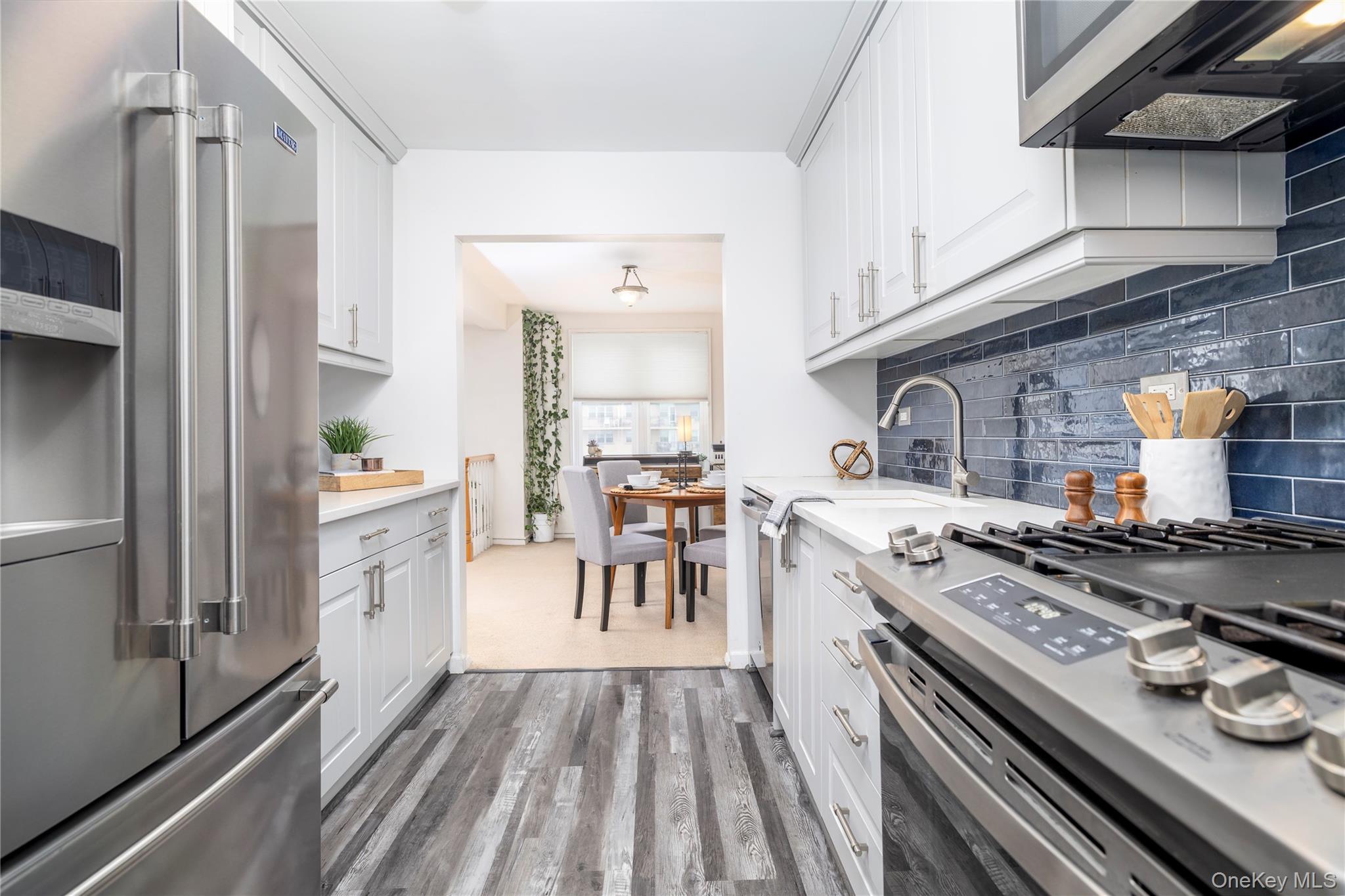 522 Shore Road, Unit 6C Long Beach, NY 11561 - Photo 11 of 25 a kitchen with a stove and a refrigerator