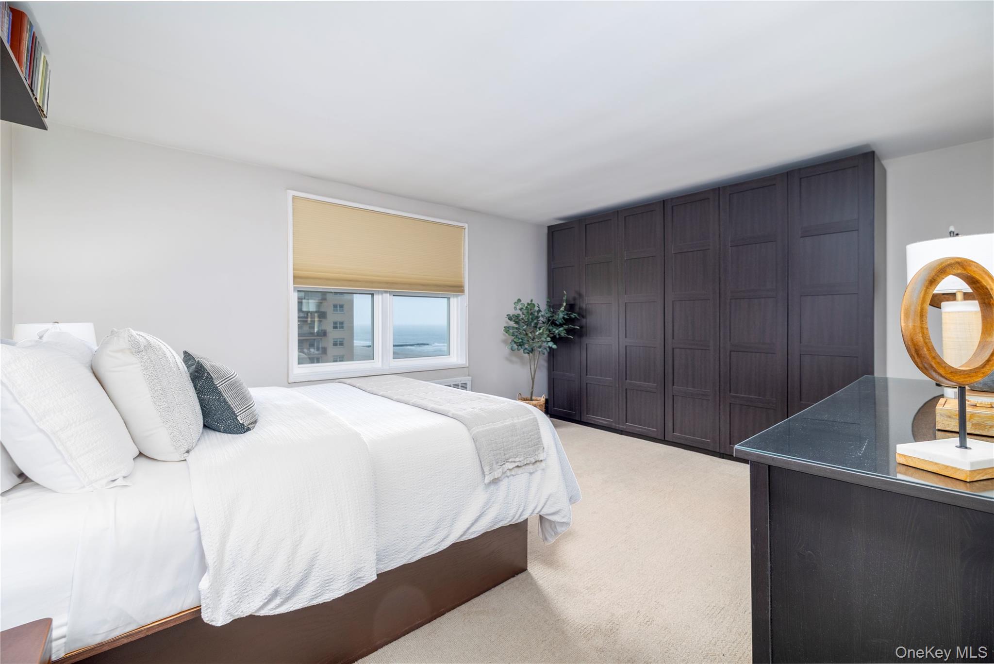 522 Shore Road, Unit 6C Long Beach, NY 11561 - Photo 12 of 25 a bedroom with a bed and a window
