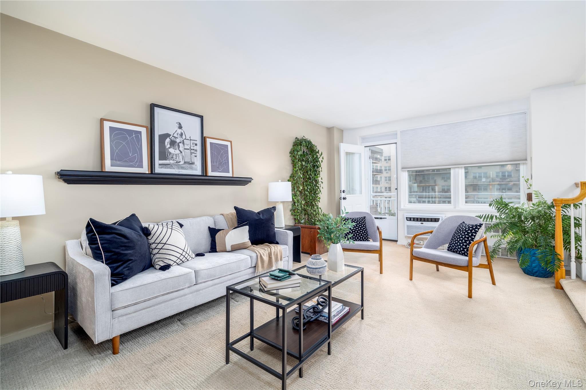 522 Shore Road, Unit 6C Long Beach, NY 11561 - Photo 2 of 25 a living room with furniture and a large window