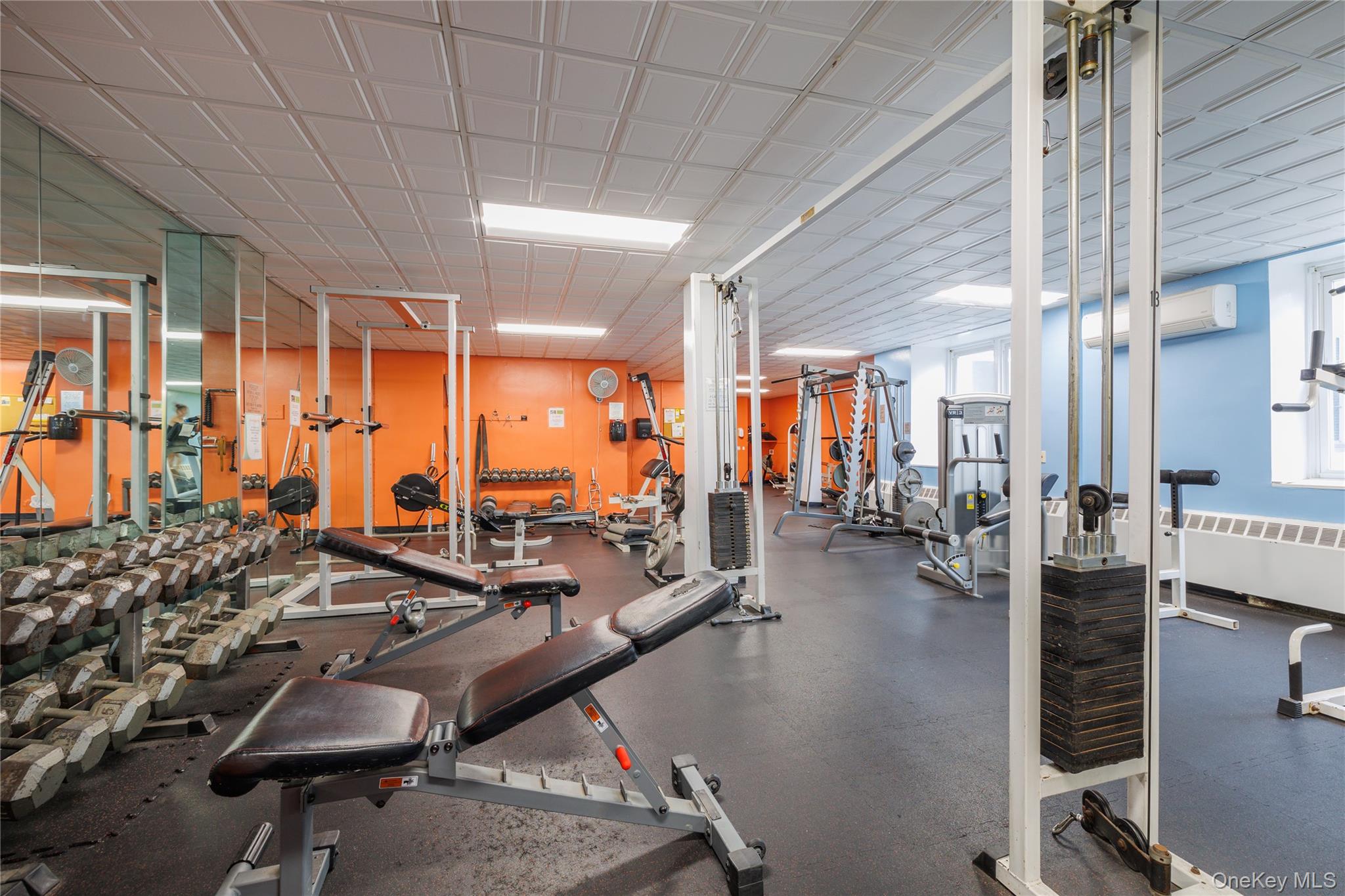 522 Shore Road, Unit 6C Long Beach, NY 11561 - Photo 22 of 25 a room with gym equipment and large windows