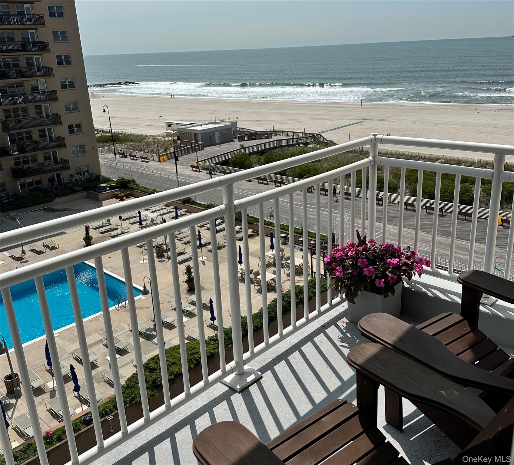 522 Shore Road, Unit 6C Long Beach, NY 11561 - Photo 5 of 25 a view of an chairs and table on the balcony