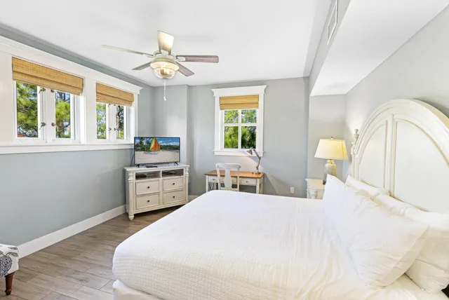 a bathroom with a sink vanity tub shower and a mirror