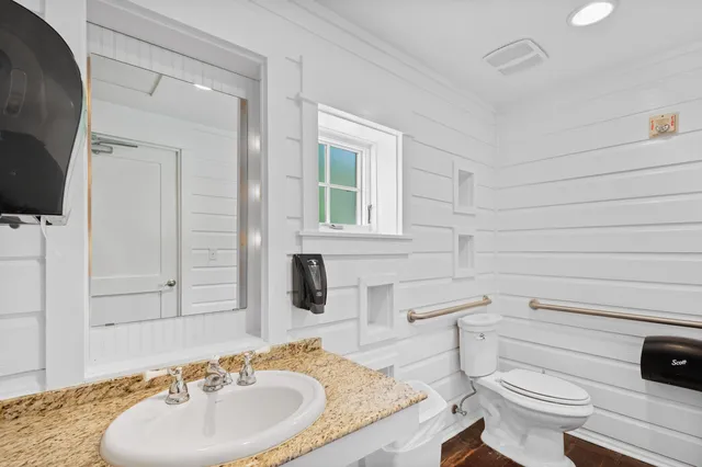 a view of a big house with a big yard and a large tree in front of it