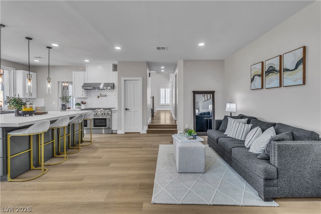 8848 Rainbow Ridge Drive Las Vegas, NV 89117 - Photo 13 of 43 An open-concept layout unites the kitchen and living room, creating a seamless flow for entertaining.