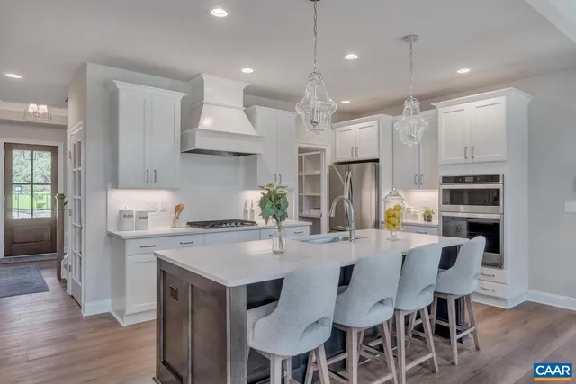 a kitchen with appliances a refrigerator and a stove top oven