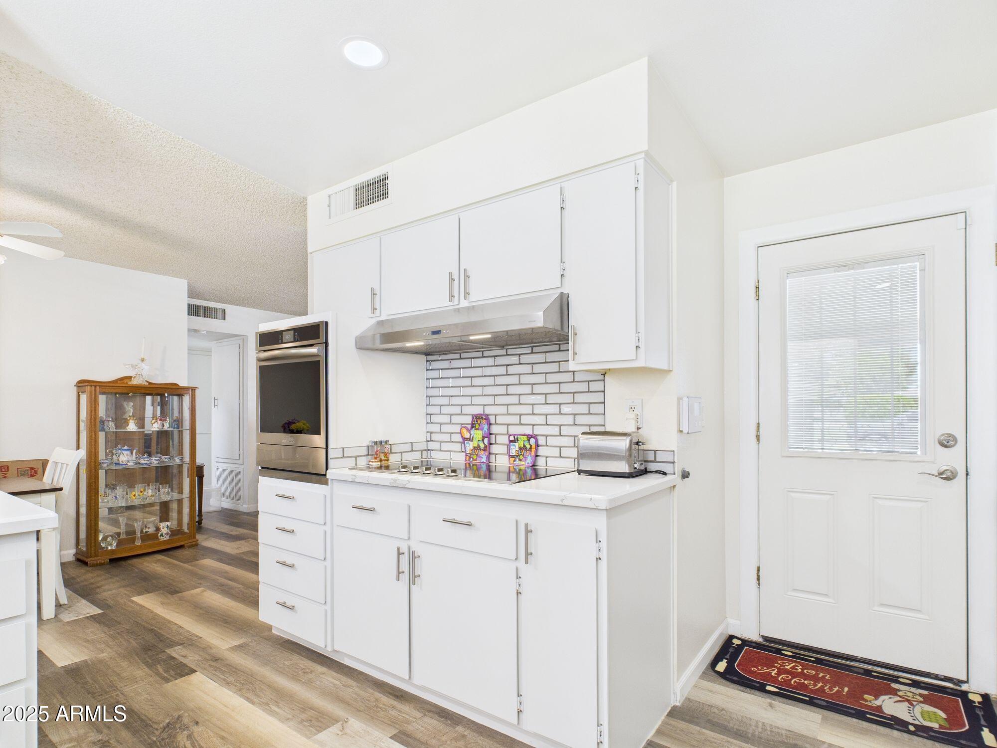 9915 West Mountain View Road Sun City, AZ 85351 - Photo 10 of 22 a kitchen with stainless steel appliances a sink stove and cabinets