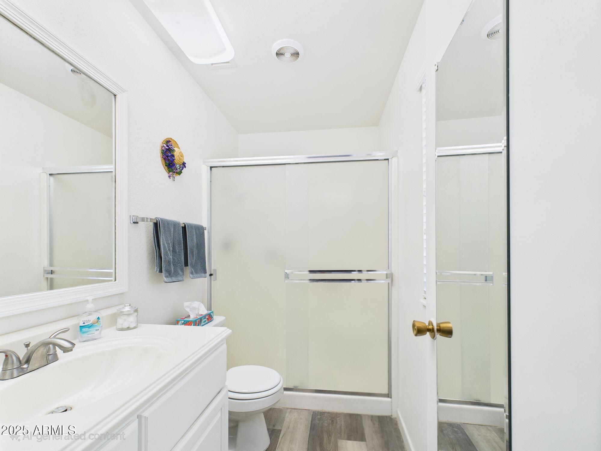 9915 West Mountain View Road Sun City, AZ 85351 - Photo 14 of 22 a bathroom with a sink toilet and shower