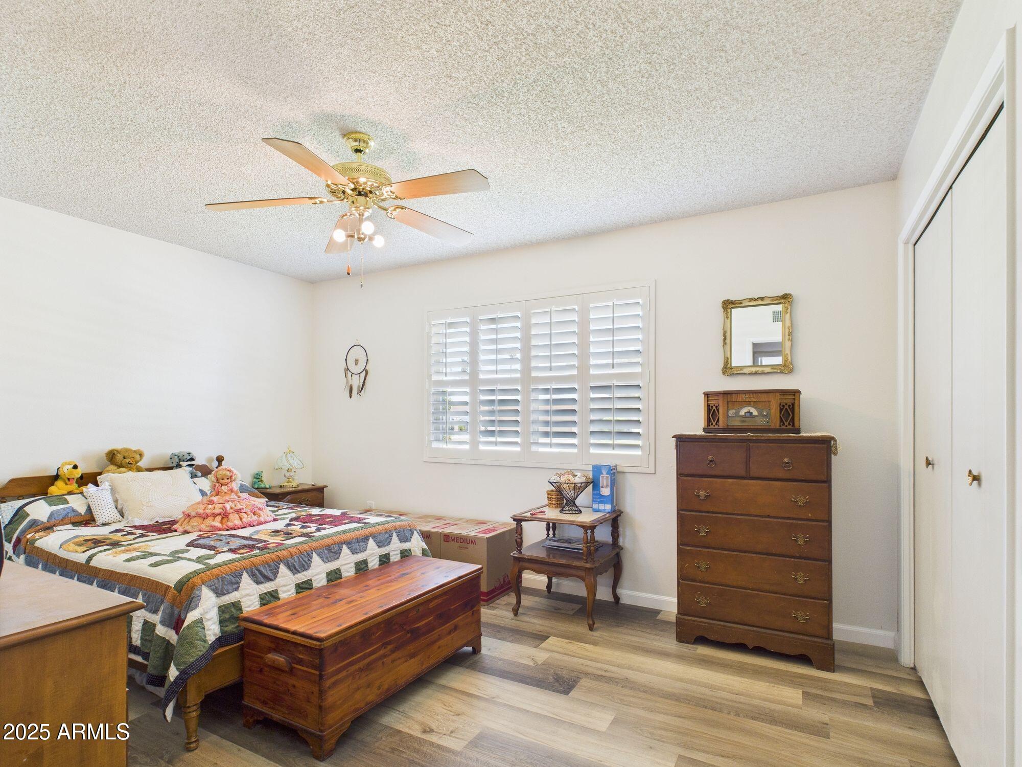 9915 West Mountain View Road Sun City, AZ 85351 - Photo 15 of 22 a bedroom with a bed and furniture