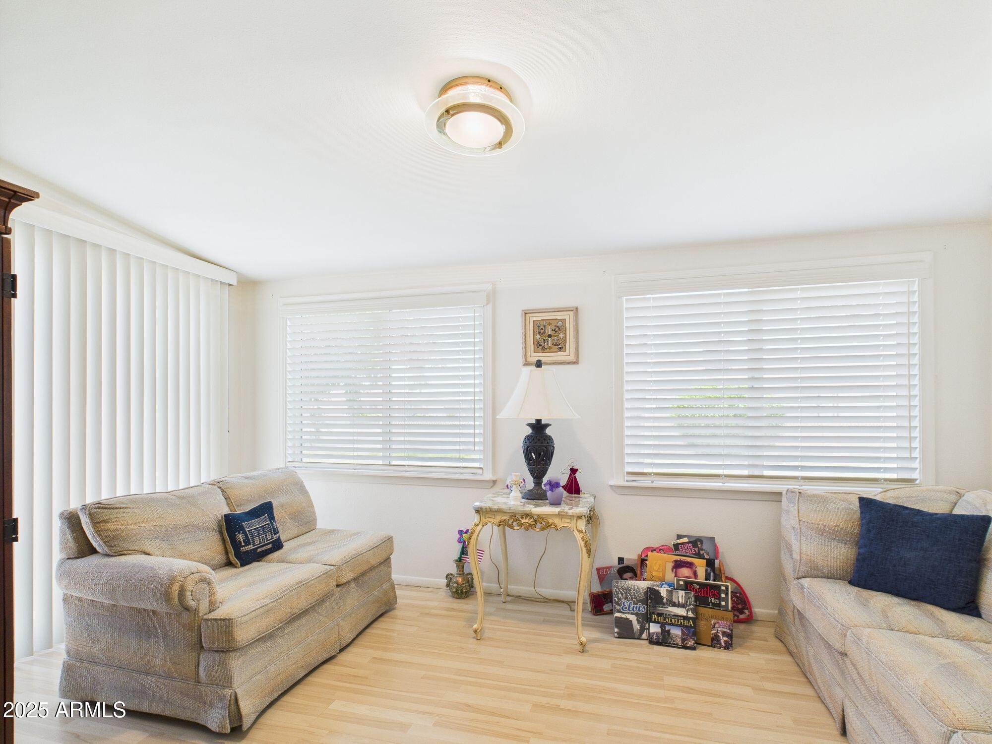 9915 West Mountain View Road Sun City, AZ 85351 - Photo 18 of 22 a living room with furniture and a window
