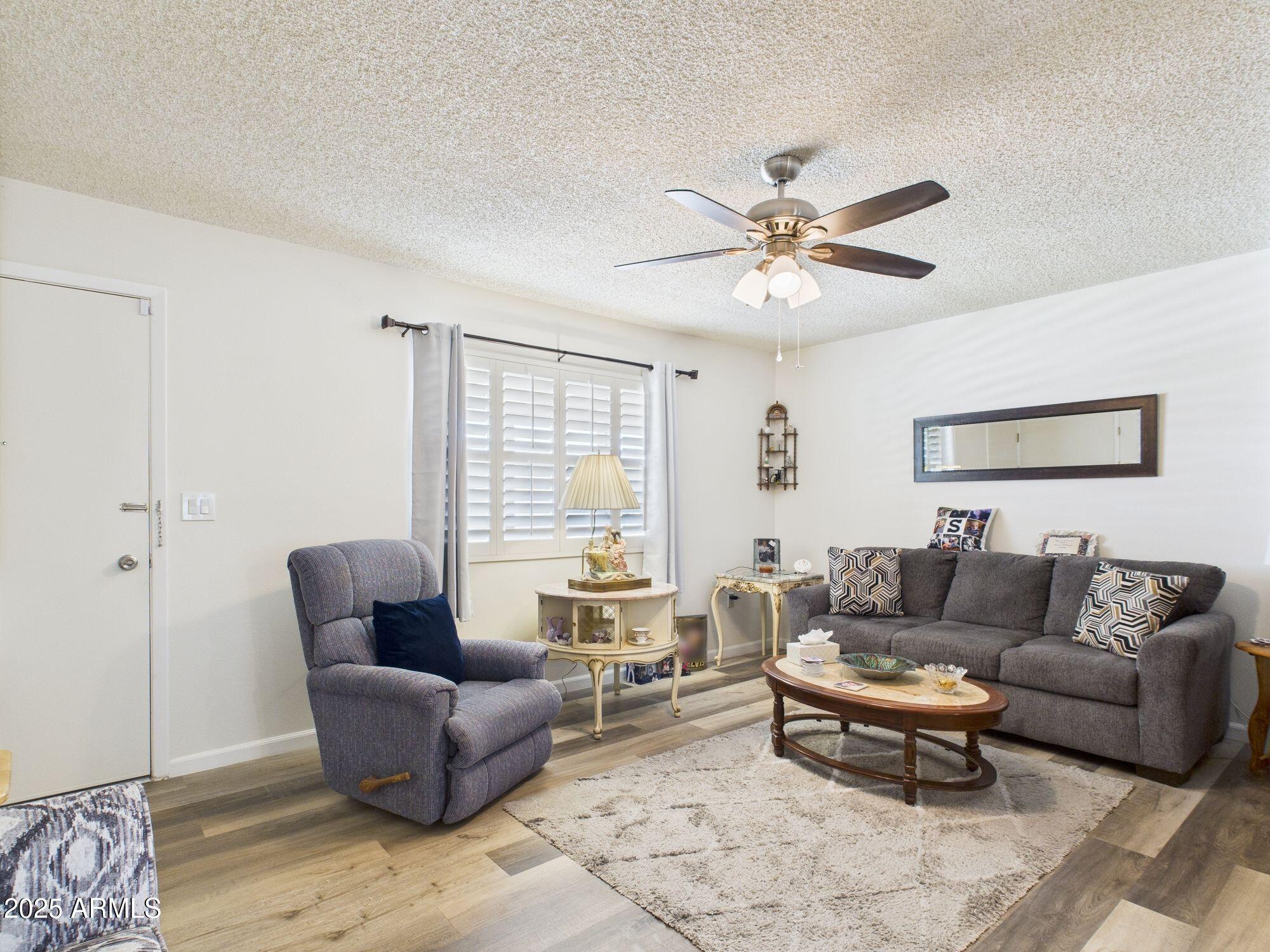 9915 West Mountain View Road Sun City, AZ 85351 - Photo 6 of 22 a living room with furniture and a large window