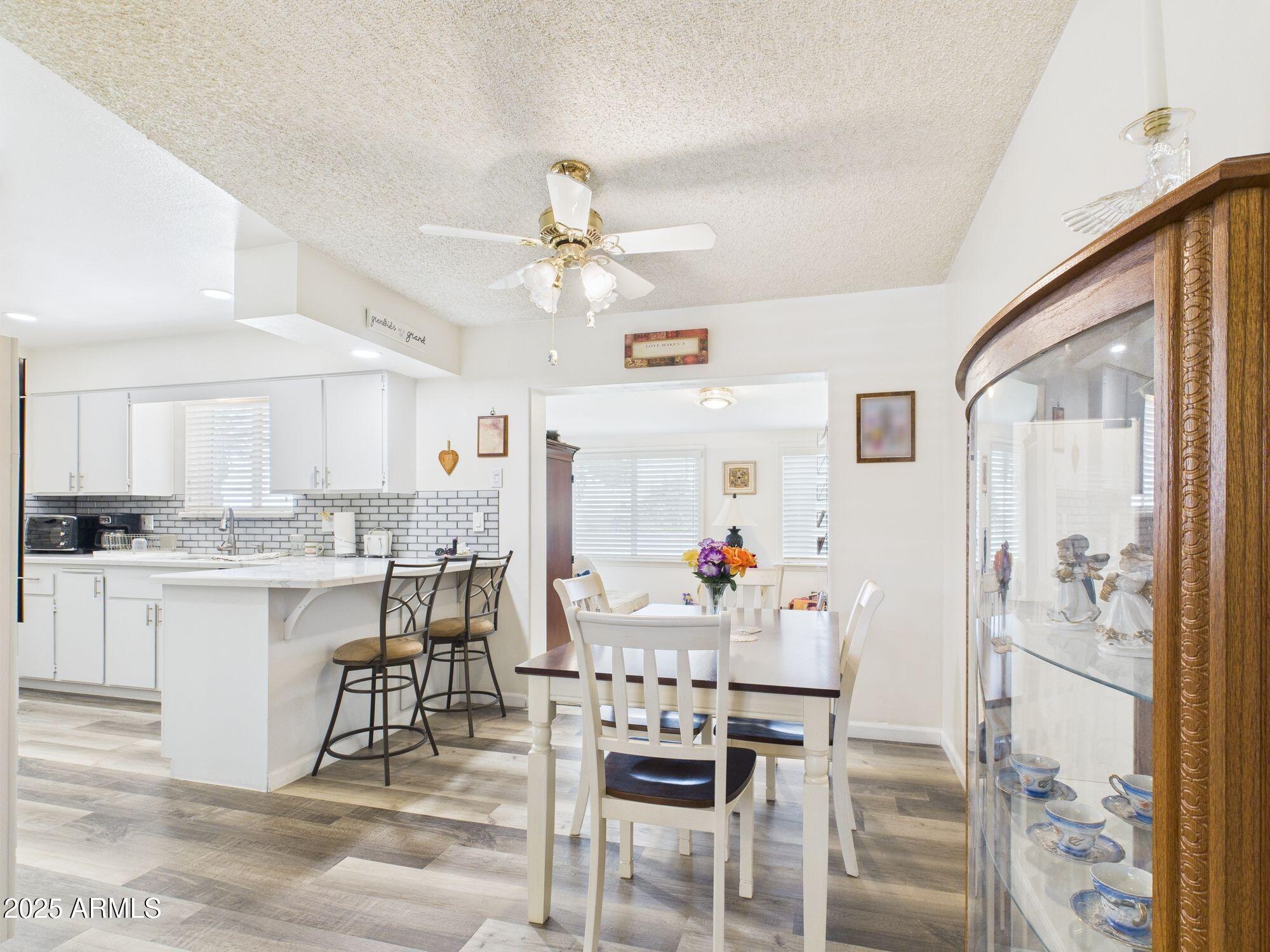 9915 West Mountain View Road Sun City, AZ 85351 - Photo 7 of 22 a view of a dining room kitchen and a window