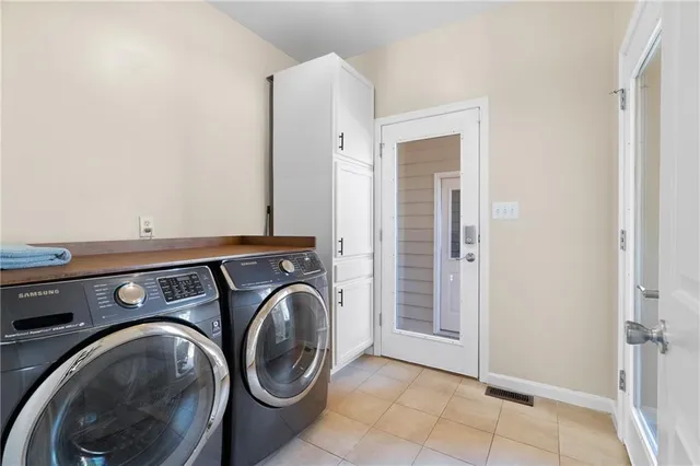 a view of an empty room with wooden floor fireplace and a window