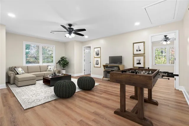 a view of an empty room with a window and wooden floor