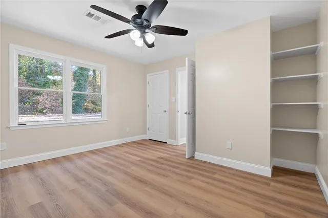 a bathroom with a shower curtain a toilet and a shower