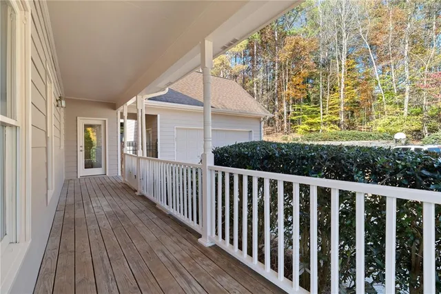 an aerial view of a house with wooden floor and outdoor seating