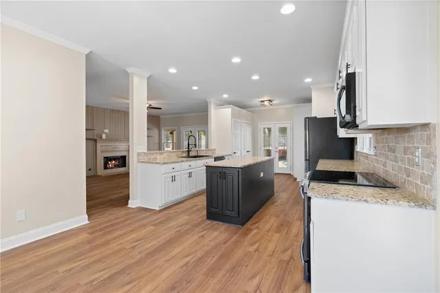 a kitchen with stainless steel appliances a stove sink and microwave