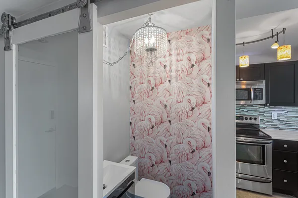 a bathroom with a granite countertop shower a toilet and a sink