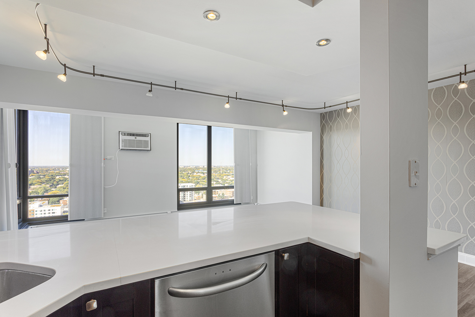 6166 North Sheridan Road, Unit 24L Chicago, IL 60660 - Photo 3 of 18 a hallway with a sink and a window