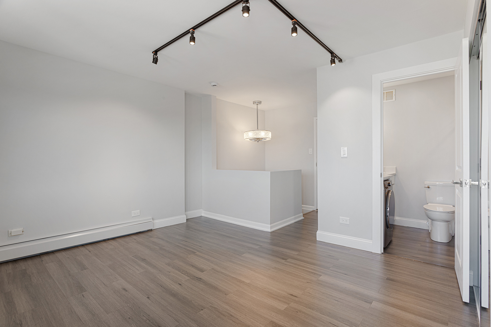 6166 North Sheridan Road, Unit 24L Chicago, IL 60660 - Photo 8 of 18 a view of a big room with wooden floor and windows