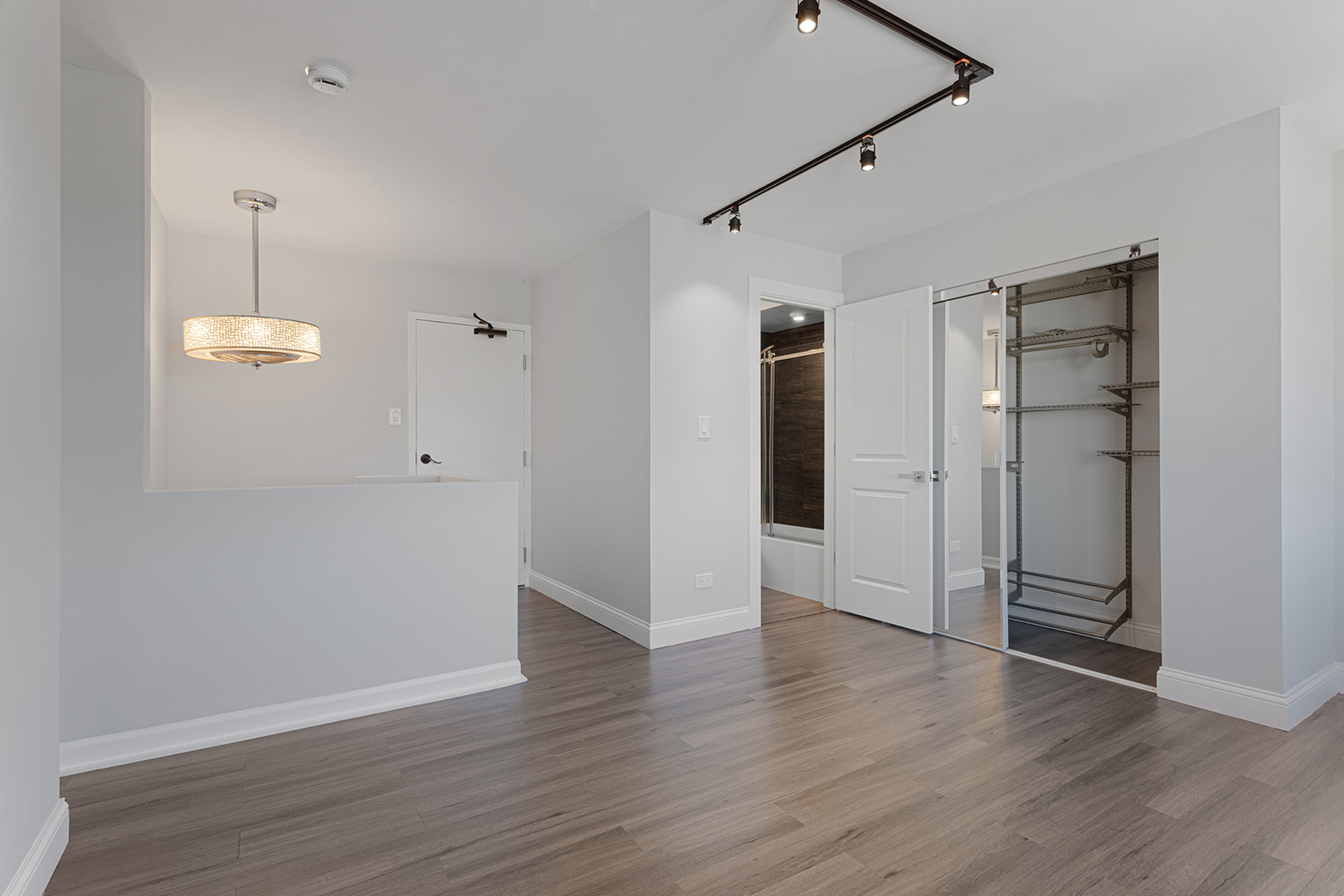 6166 North Sheridan Road, Unit 24L Chicago, IL 60660 - Photo 9 of 18 an empty room with wooden floor and window