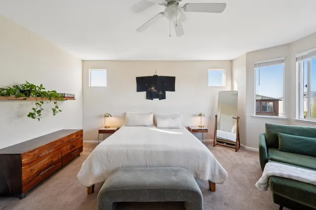 a bed room with a bed window and a chair