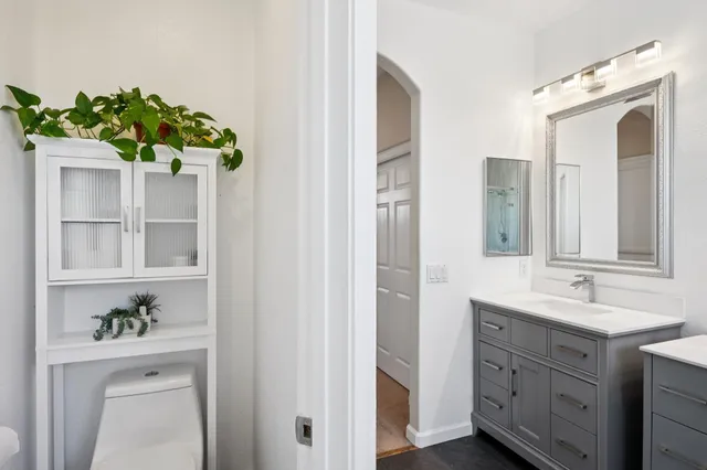 a bathroom with a sink a vanity and a mirror