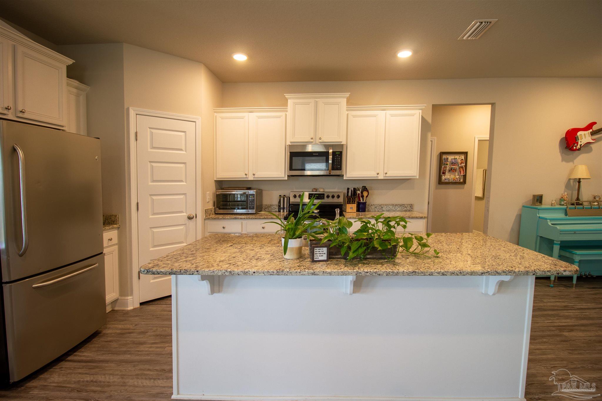 5375 Red Shoulder Road Milton, FL 32571 - Photo 11 of 38 a kitchen with stainless steel appliances granite countertop a refrigerator and a stove