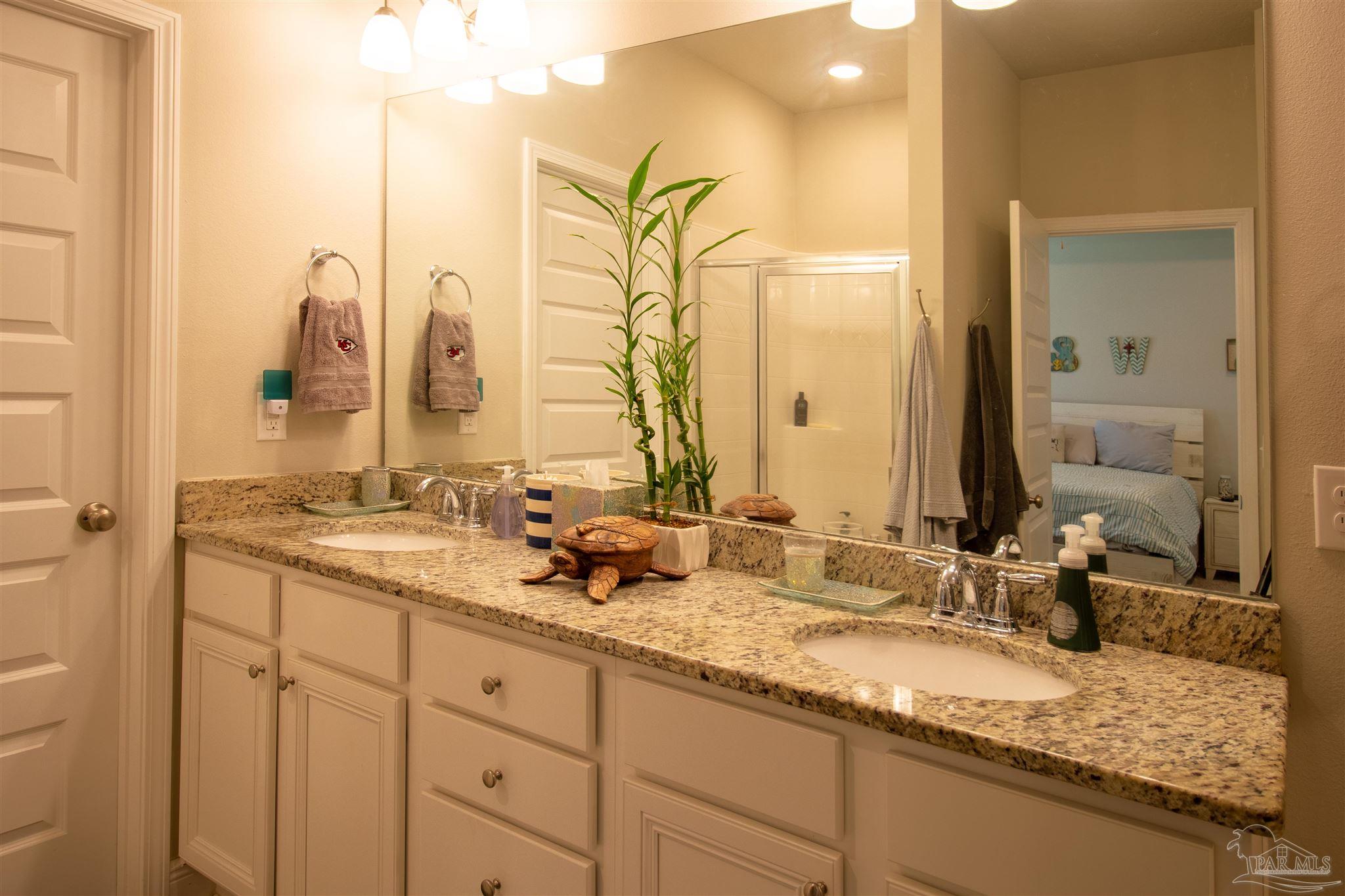 5375 Red Shoulder Road Milton, FL 32571 - Photo 17 of 38 a bathroom with a granite countertop sink and a mirror