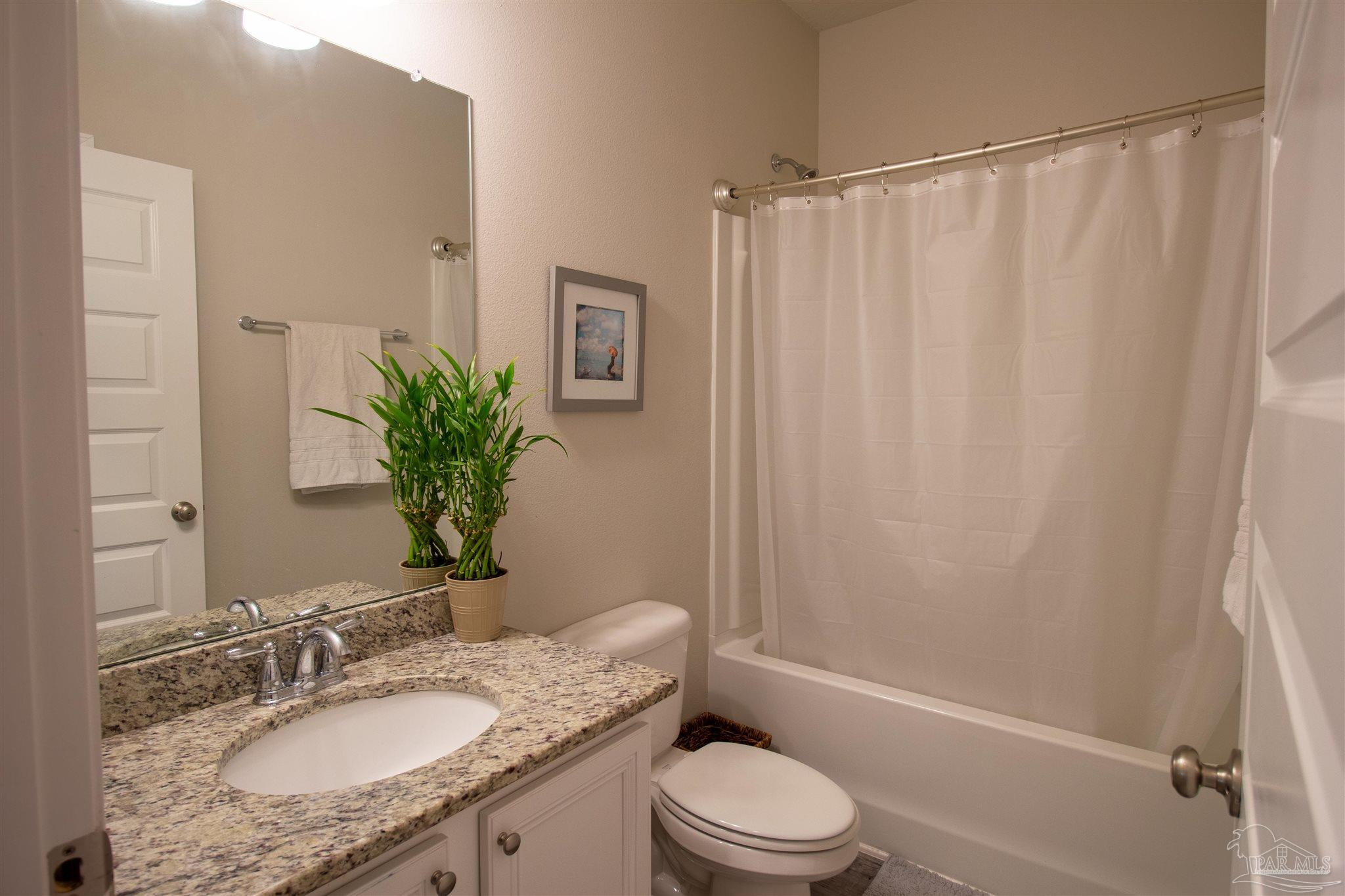 5375 Red Shoulder Road Milton, FL 32571 - Photo 23 of 38 a bathroom with a granite countertop sink toilet and shower