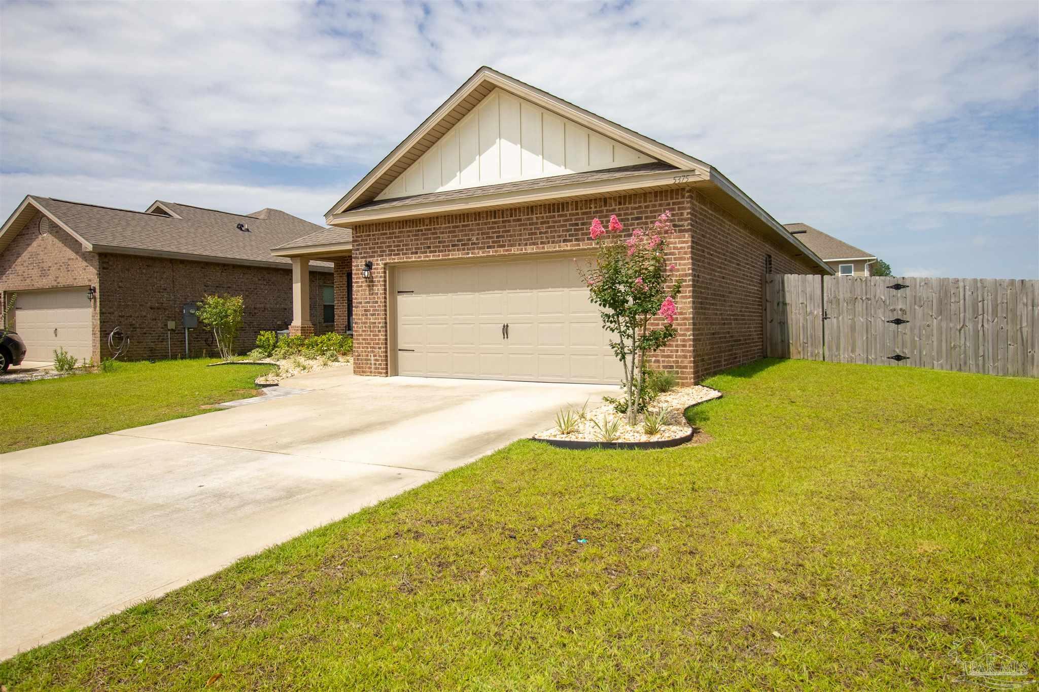 5375 Red Shoulder Road Milton, FL 32571 - Photo 3 of 38 a view of a house with yard and garage