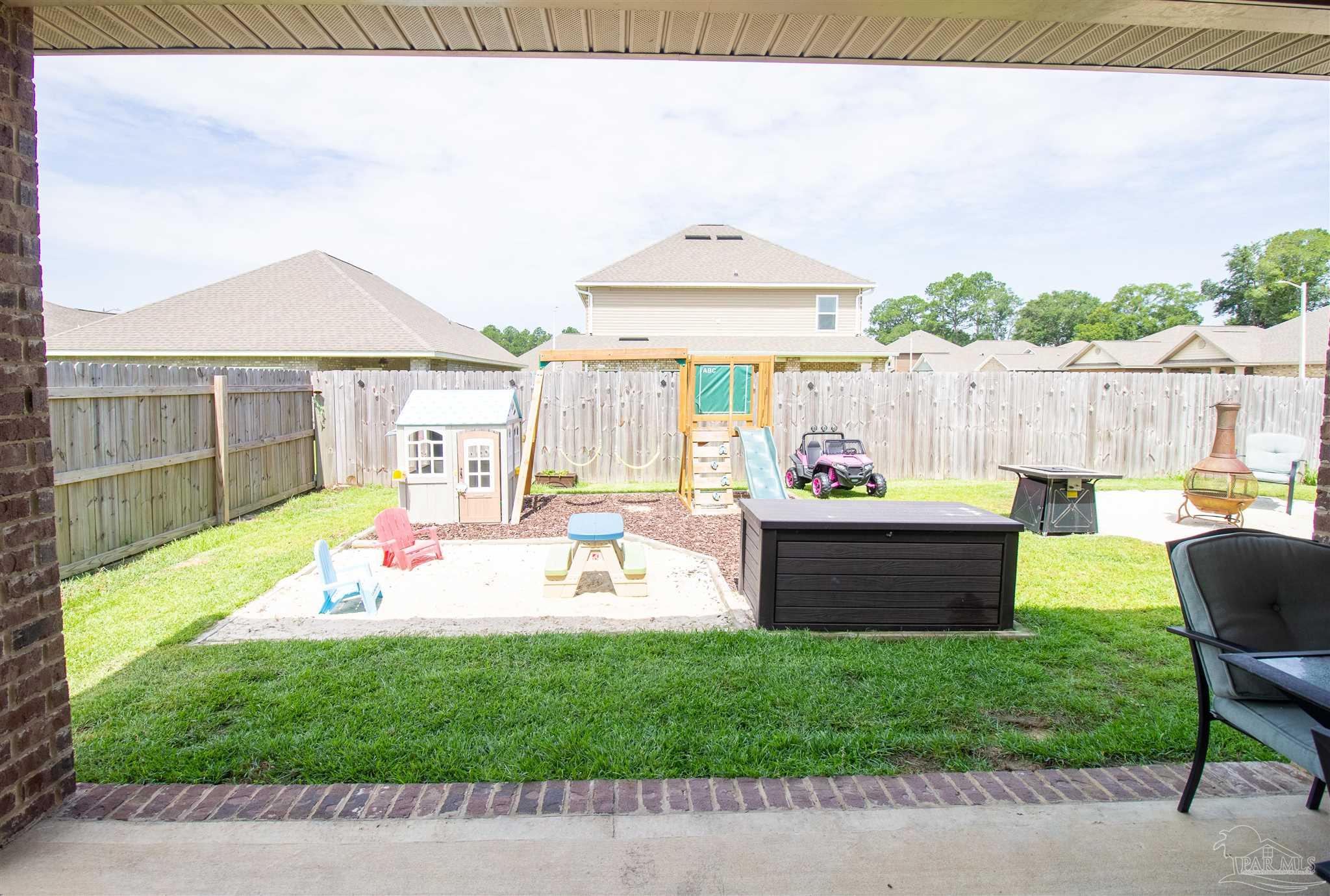 5375 Red Shoulder Road Milton, FL 32571 - Photo 32 of 38 a view of a backyard with a garden and patio