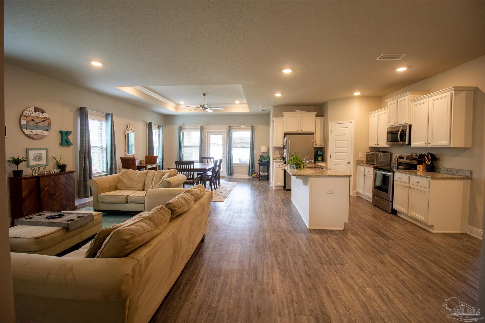 5375 Red Shoulder Road Milton, FL 32571 - Photo 5 of 38 a living room with stainless steel appliances furniture cabinets and a wooden floor